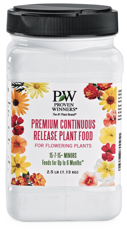 A clear container with a black lid of "Proven Winners Premium Continuous Release Plant Food" for flowering plants, 15-7-15 formula, 2.5 lb, bordered by colorful flowers.